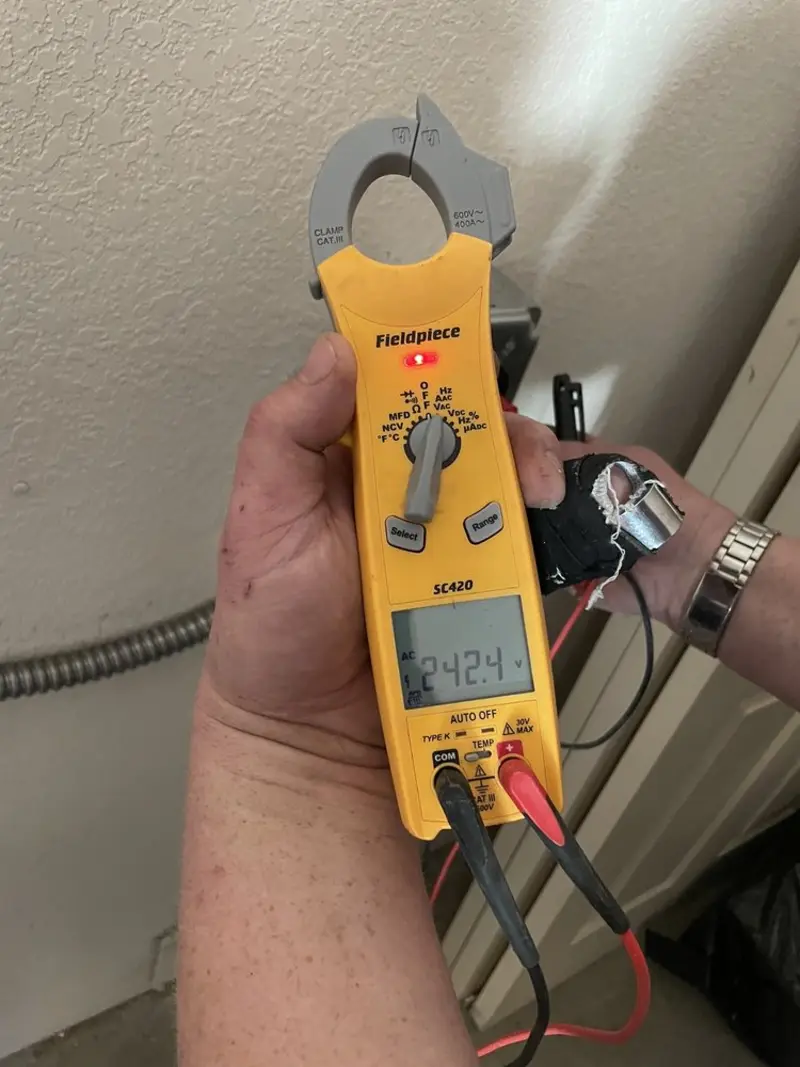 Voltage testing with clamp meter during Outlet Installation in East Allen